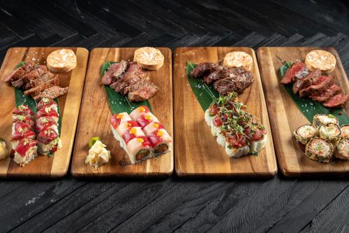 Four wooden platters display an assortment of sushi and grilled meats, garnished with sauces and herbs.