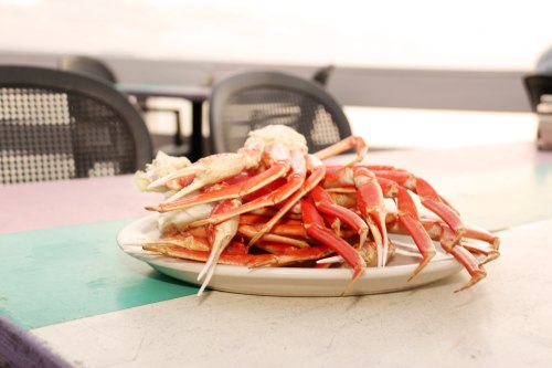A plate of freshly cooked crab legs on a colorful table, ready to be served.