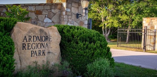 Sign for Ardmore Regional Park with stone entrance and greenery in the background.