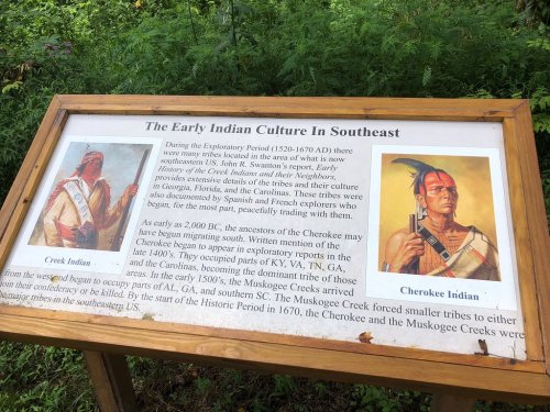 Image of a sign detailing the early Indian culture in the Southeast, featuring illustrations of a Creek Indian and a Cherokee Indian.