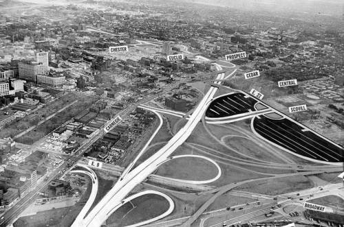 Aerial view of a city with labeled streets and highways, showcasing urban development and road intersections.