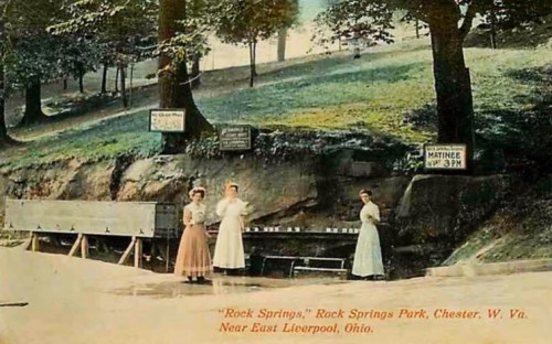 Vintage postcard of three women in white dresses at Rock Springs Park, with signs and a scenic background in West Virginia.