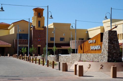 Town Hall of Sahuarita, featuring a modern building with a stone sign and landscaped area under a clear blue sky.