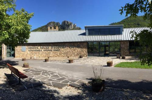 Exterior view of the Seneca Rocks Discovery Center, featuring stone architecture and a mountain backdrop.