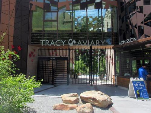 Entrance to Tracy Aviary featuring a modern design, with a sign for admission and decorative elements.