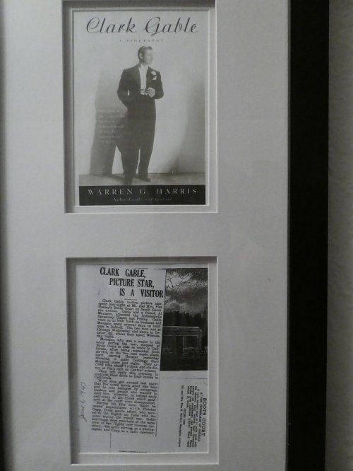 Framed display featuring a biography of Clark Gable and a newspaper article about his visit, dated January 1947.