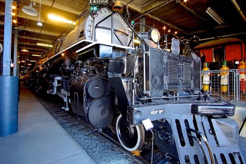 A close-up of a vintage steam locomotive in a museum, showcasing its intricate details and machinery.