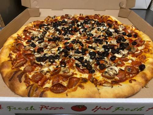 A large pizza topped with pepperoni, mushrooms, and black olives in a pizza box.