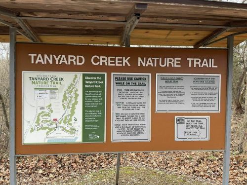 Sign for Tanyard Creek Nature Trail, featuring a map and safety guidelines for visitors.