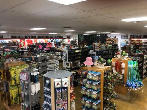 A spacious retail store filled with various outdoor and camping gear, clothing, and accessories on display.