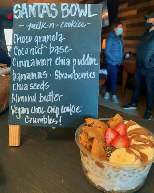 A chalkboard menu lists "Santa's Bowl" ingredients: granola, coconut base, chia pudding, bananas, strawberries, and almond butter.
