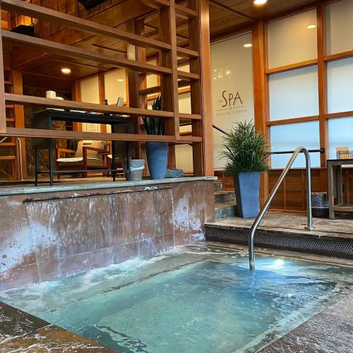 A serene spa area featuring a small hot tub, wooden accents, and a welcoming atmosphere.