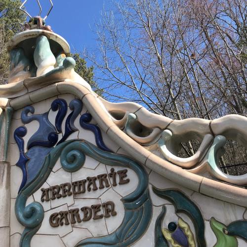 Colorful tiled archway with the words "Arranmore Garden" against a clear blue sky and bare trees in the background.