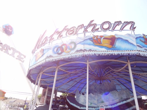 Colorful carnival ride named "Matterhorn" with a bright sky in the background and decorative icy designs.