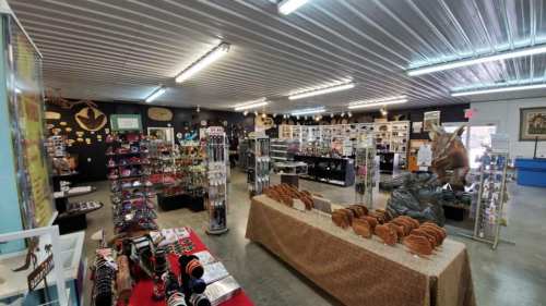 Interior of a gift shop featuring various displays of souvenirs, jewelry, and decorative items in a well-lit space.