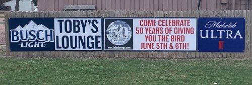 Banner advertising Toby's Lounge, celebrating 50 years with events on June 5th and 6th, featuring Busch Light and Michelob Ultra.