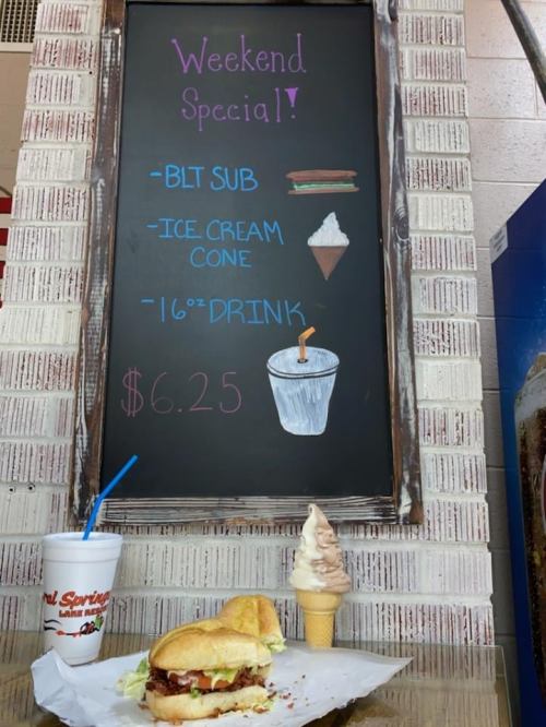 Chalkboard menu displaying weekend specials: BLT sub, ice cream cone, and a drink, priced at $6.25.