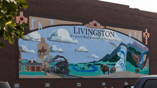 Mural depicting Livingston as the original rail gateway to Yellowstone, featuring a train, mountains, and wildlife.