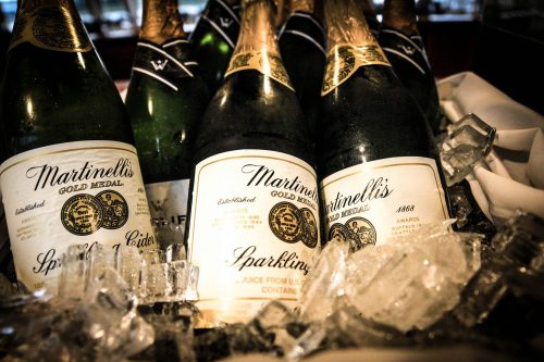 Bottles of Martinelli's Gold Medal sparkling cider nestled in ice.