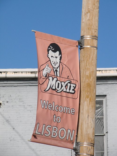 A banner featuring a man pointing, advertising Moxie and welcoming visitors to Lisbon.