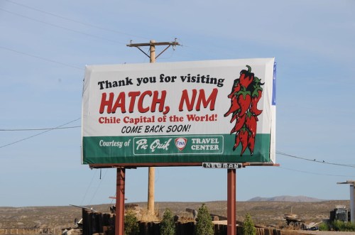 Billboard welcoming visitors to Hatch, NM, the "Chile Capital of the World," encouraging them to return soon.