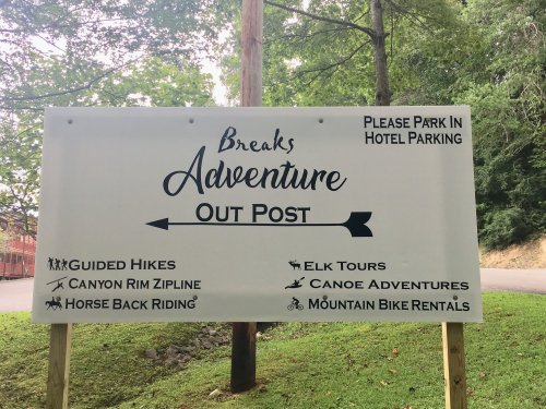 Sign for Breaks Adventure Out Post listing activities like guided hikes, ziplining, elk tours, and more.