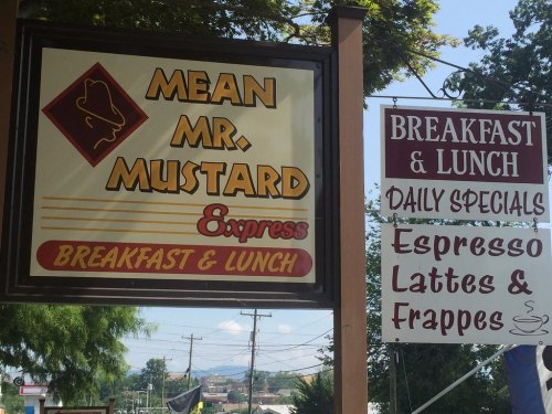 Sign for "Mean Mr. Mustard Express" featuring breakfast and lunch options, with a focus on espresso, lattes, and frappes.