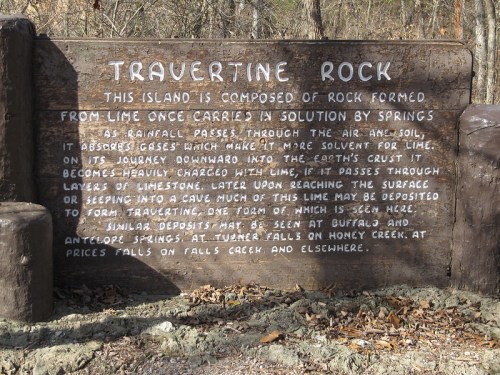 Sign about Travertine Rock, explaining its formation from lime carried by springs and its geological features.
