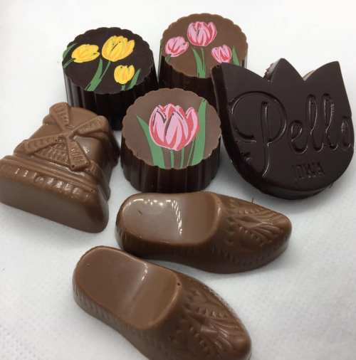 A variety of decorative chocolates, including floral designs and shaped like clogs and a windmill.
