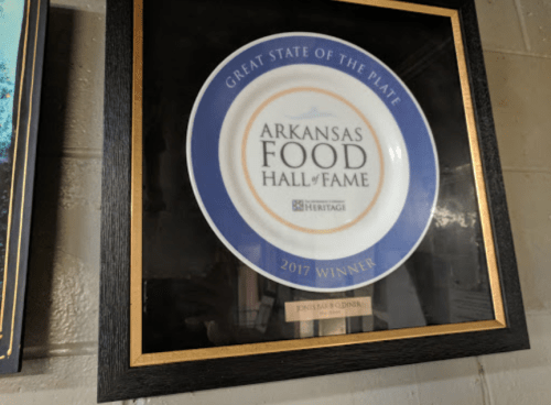 Framed award plaque for the Arkansas Food Hall of Fame, 2017 winner, displayed on a wall.