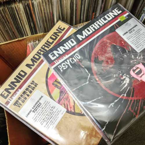 Two vinyl records by Ennio Morricone, titled "Western" and "Psycho," displayed in protective sleeves.