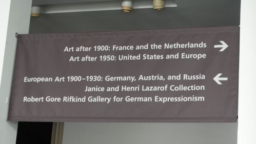 Signage displaying art exhibition titles and collections, including European art and German Expressionism.
