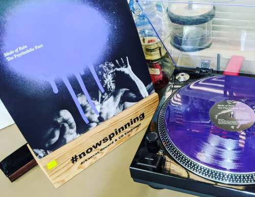 A vinyl record of "Made of Rain" by The Psychedelic Furs spinning on a turntable, with a colorful album cover.