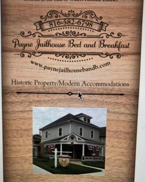 Sign for Payne Jailhouse Bed and Breakfast, featuring a historic property with modern accommodations. Contact info included.