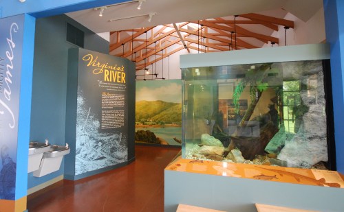 Interior of a museum exhibit featuring a large aquarium and informational displays about Virginia's rivers.