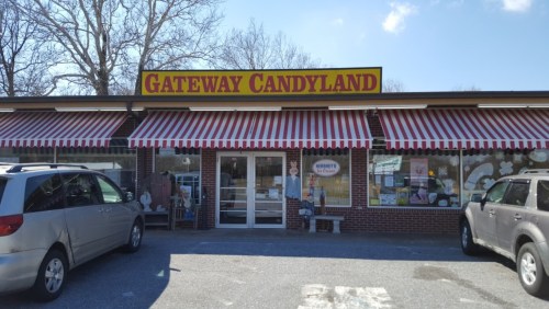 Exterior of Gateway Candyland, featuring red and white striped awnings and a welcoming entrance.