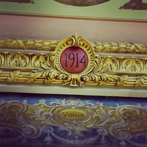 Ornate gold frame featuring the year "1914" and the word "Venice" in decorative lettering.