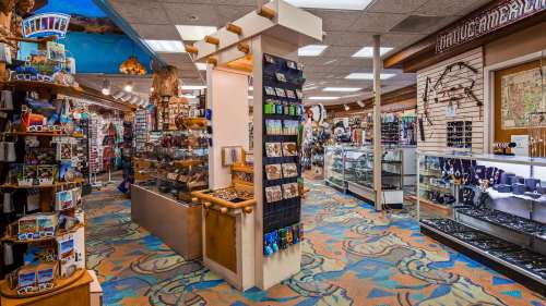 A colorful gift shop interior filled with souvenirs, jewelry displays, and decorative items.