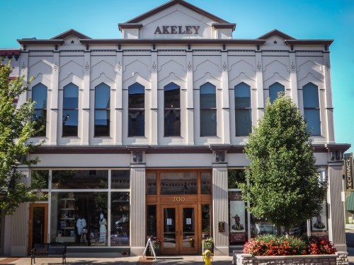 Historic building with a decorative facade, large windows, and a sign reading "AKELEY" above the entrance.
