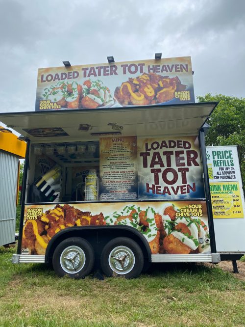 A food truck named "Loaded Tater Tot Heaven" featuring a menu of loaded tater tots and drink options.