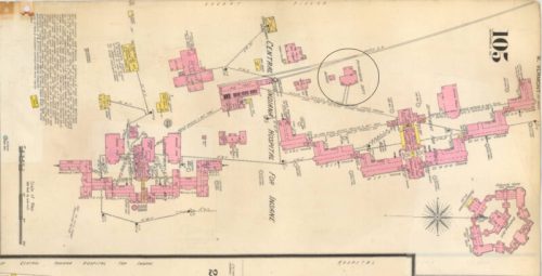A historical map showing buildings and layout, with highlighted areas and labels, indicating various structures and paths.