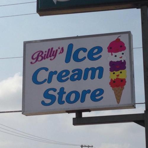 Sign for "Billy's Ice Cream Store" featuring colorful ice cream cones and a bright blue background.