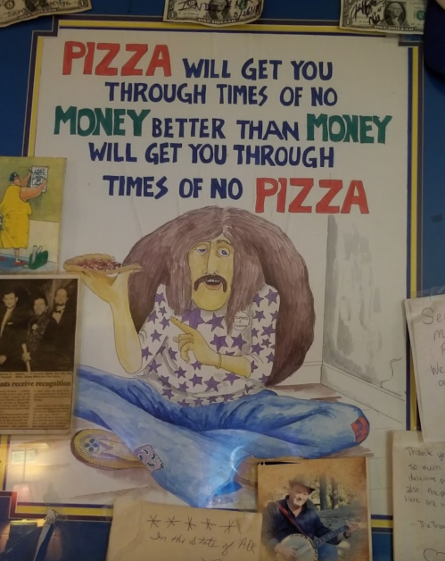 A colorful poster featuring a cartoonish man holding a slice of pizza, with a humorous quote about pizza and money.