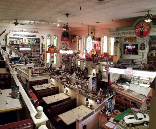 A vintage diner interior with retro decor, booths, and memorabilia, featuring a nostalgic Route 66 theme.