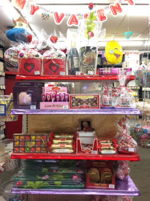 A display of Valentine's Day gifts, including chocolates, stuffed animals, and decorative items, in a store.