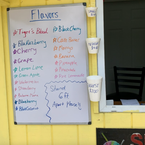 A colorful menu board listing various flavors like Tiger's Blood, Black Cherry, and more, with prices for small and medium sizes.