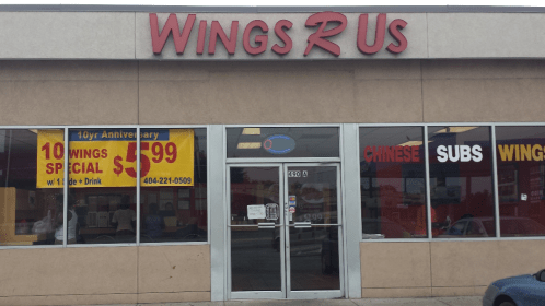 Exterior of Wings R Us restaurant with a sign advertising a 10-wing special for $5.99 and a 10-year anniversary celebration.