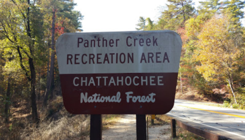 Sign for Panther Creek Recreation Area in Chattahoochee National Forest, surrounded by colorful autumn trees.