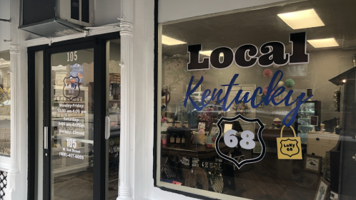 Storefront window displaying "Local Kentucky 68" with business hours and address.