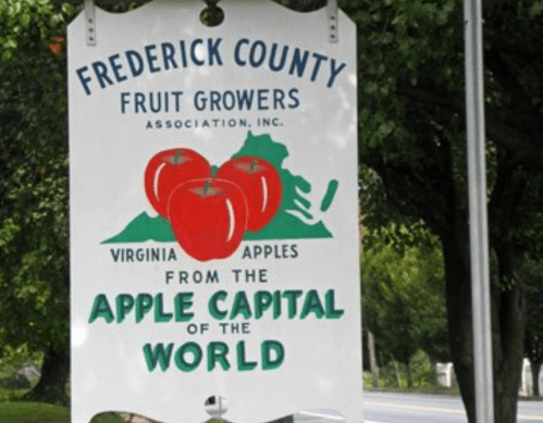 Sign for Frederick County Fruit Growers Association, featuring red apples and text about Virginia apples and the Apple Capital.